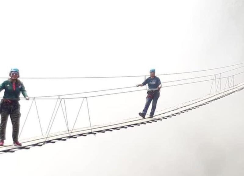 Personas cruzando el puente tibetano en Tlatlauquitepec