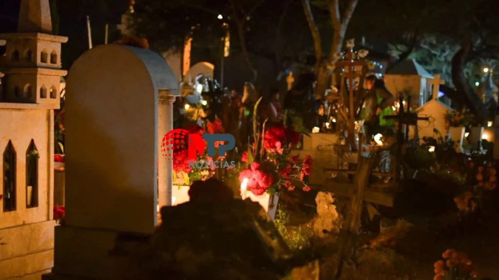Así lucen las tumbas adornadas en Coyotepec durante quema de cera por Día de Muertos.