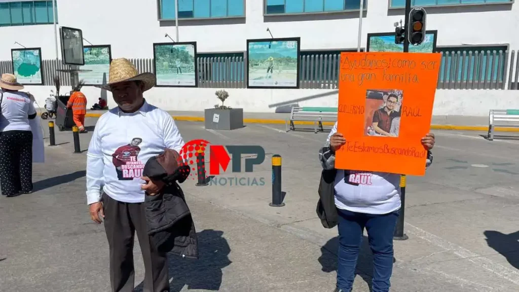 Famiiare de Raúl, desaparecido en Puebla, protestan con cartulinas frente a Fiscalía de Puebla.